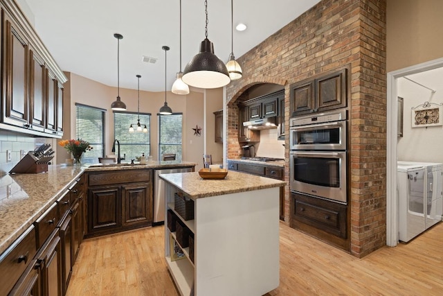 7303 Bluntleaf Cv, Austin, TX 78750 - kitchen with washer and dryer, appliances with stainless steel finishes, open shelves, and backsplash