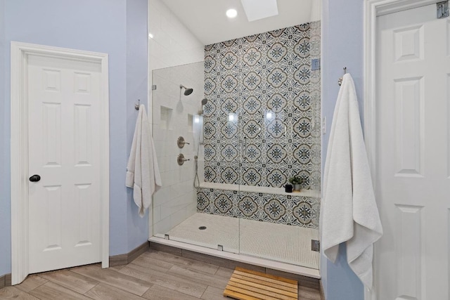 7303 Bluntleaf Cv, Austin, TX 78750 - full bath featuring a tile shower, wood finished floors, a skylight, and recessed lighting