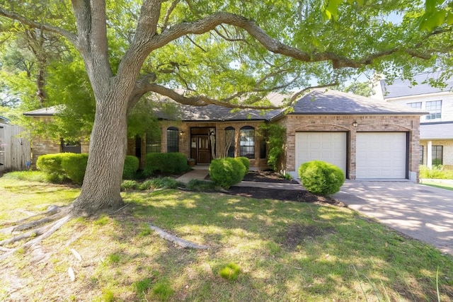 7303 Bluntleaf Cv, Austin, TX 78750 - view of front facade featuring an attached garage, driveway, brick siding, and a chimney