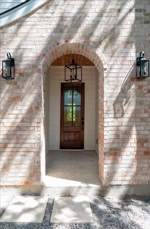 property entrance with brick siding
