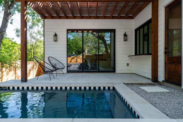 swimming pool with a pergola and a patio area