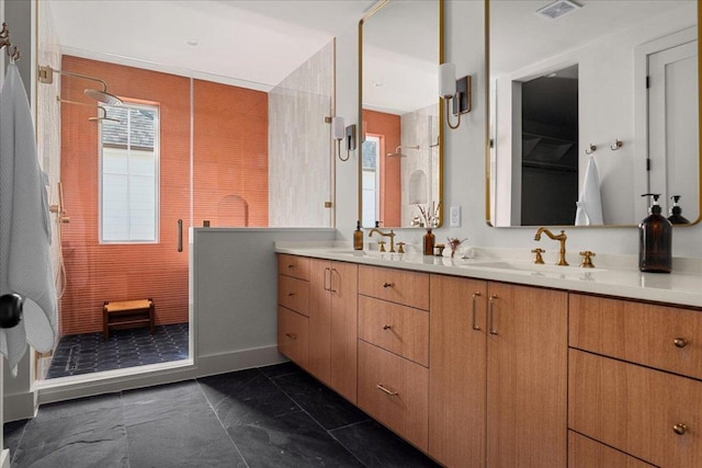bathroom with a shower stall and double vanity