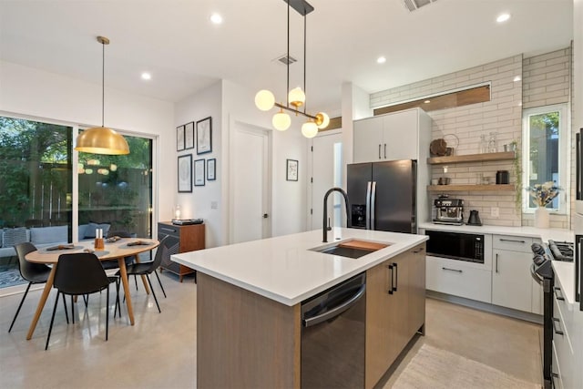 4907 Delores Ave, Austin, TX 78721 - kitchen featuring black appliances, a sink, recessed lighting, light countertops, and decorative backsplash