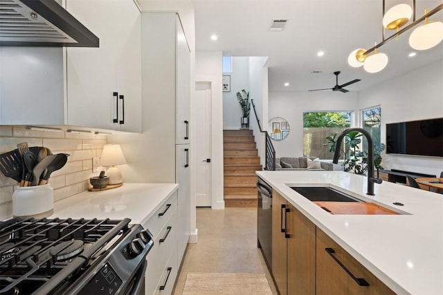 4907 Delores Ave, Austin, TX 78721 - kitchen with appliances with stainless steel finishes, extractor fan, a ceiling fan, a sink, and open floor plan