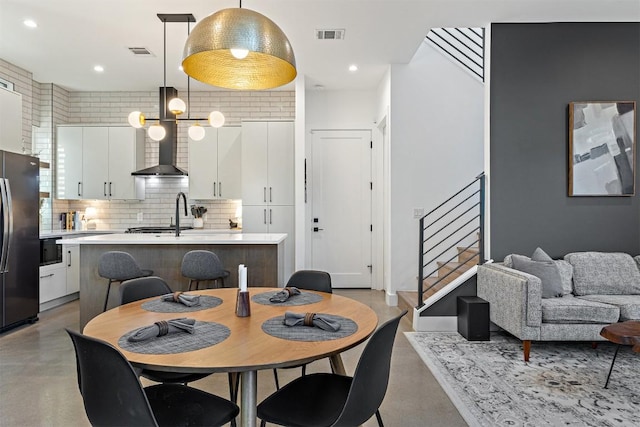 4907 Delores Ave, Austin, TX 78721 - dining area featuring concrete flooring, stairway, and recessed lighting