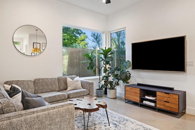 4907 Delores Ave, Austin, TX 78721 - living room with concrete floors and baseboards