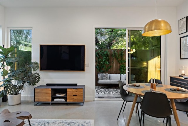 4907 Delores Ave, Austin, TX 78721 - dining room featuring concrete floors and baseboards