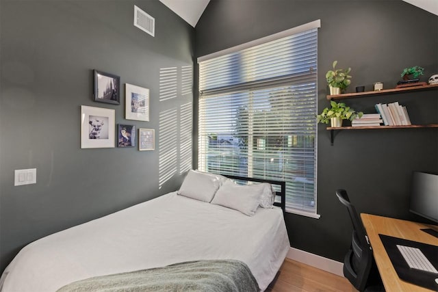 4907 Delores Ave, Austin, TX 78721 - bedroom with wood finished floors, a desk, lofted ceiling, and baseboards