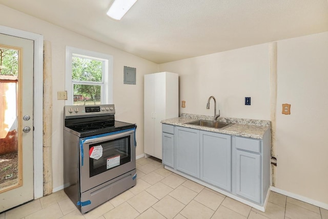 300 W Cleveland St, Elgin, TX 78621 - kitchen with stainless steel electric stove, light countertops, gray cabinets, and light tile patterned floors