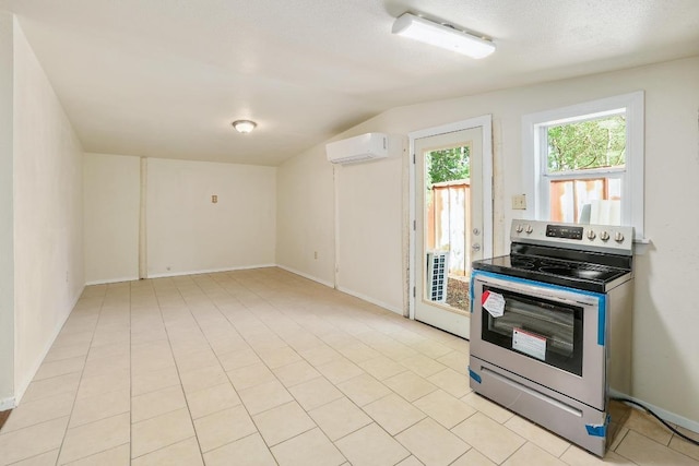300 W Cleveland St, Elgin, TX 78621 - kitchen featuring stainless steel range with electric cooktop, a wall mounted air conditioner, vaulted ceiling, and heating unit