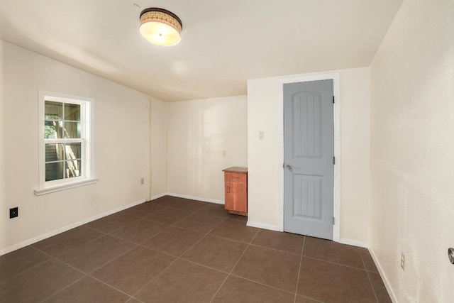 300 W Cleveland St, Elgin, TX 78621 - unfurnished room featuring dark tile patterned flooring and baseboards