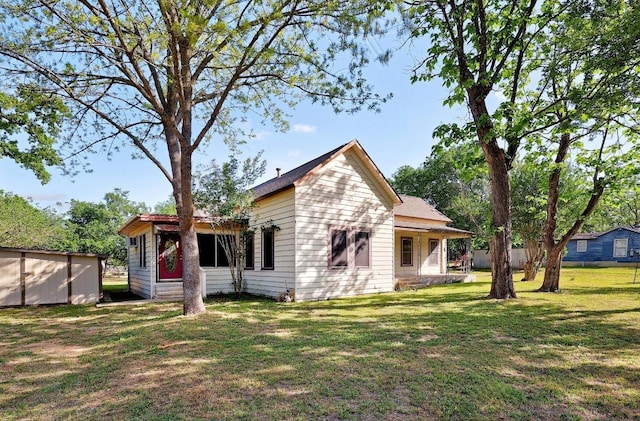 300 W Cleveland St, Elgin, TX 78621 - rear view of house featuring a lawn