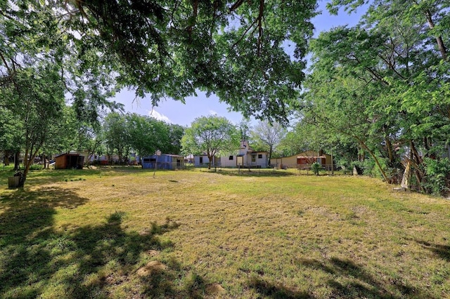 300 W Cleveland St, Elgin, TX 78621 - view of grassy yard with a shed