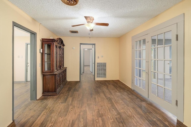 300 W Cleveland St, Elgin, TX 78621 - spare room with french doors, wood finished floors, a textured ceiling, and a ceiling fan