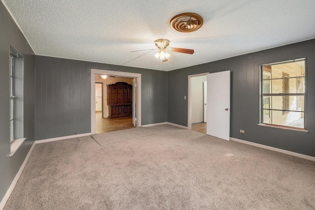 300 W Cleveland St, Elgin, TX 78621 - spare room featuring a ceiling fan, carpet, and a textured ceiling