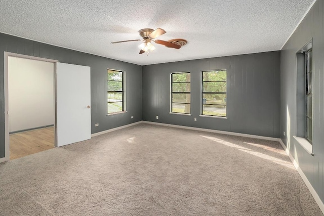 300 W Cleveland St, Elgin, TX 78621 - unfurnished bedroom with carpet flooring, a textured ceiling, and ceiling fan