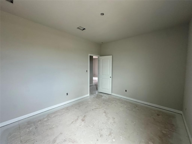 empty room with concrete floors and baseboards