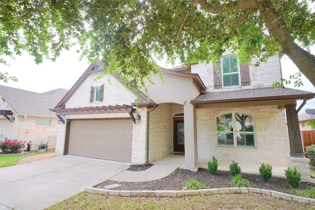 11721 Quintana Cv, Austin, TX 78739 - view of front of home featuring stone siding, concrete driveway, and roof with shingles