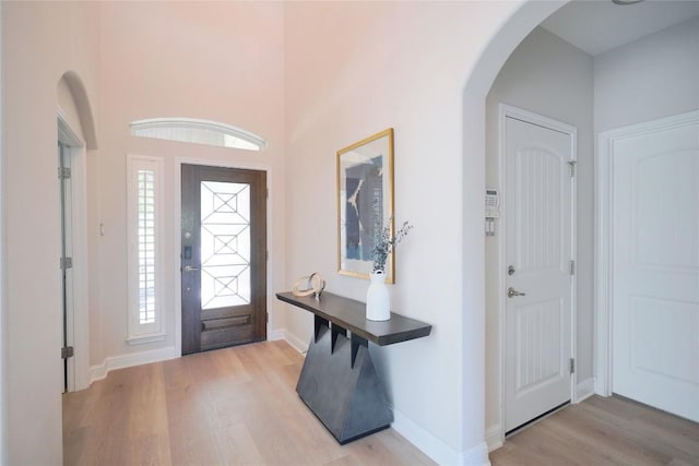 11721 Quintana Cv, Austin, TX 78739 - entryway featuring wood finished floors, arched walkways, and baseboards