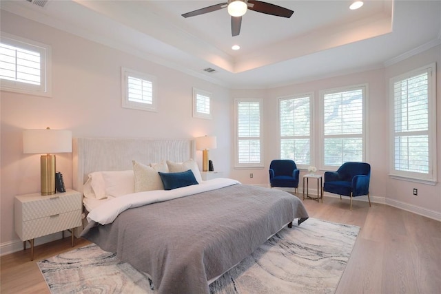 11721 Quintana Cv, Austin, TX 78739 - bedroom with a raised ceiling, light wood finished floors, multiple windows, crown molding, and recessed lighting