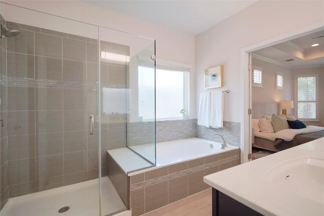 11721 Quintana Cv, Austin, TX 78739 - bathroom with a stall shower, a garden tub, vanity, crown molding, and wood finished floors