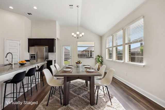 dining room featuring dark wood finished floors, visible vents, baseboards, and a notable chandelier
