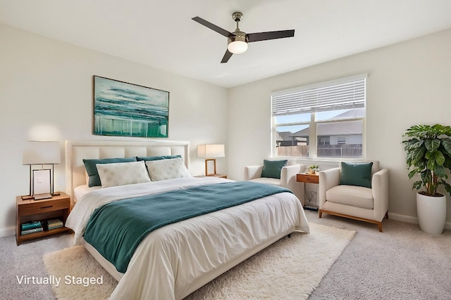 bedroom with a ceiling fan, carpet flooring, and baseboards
