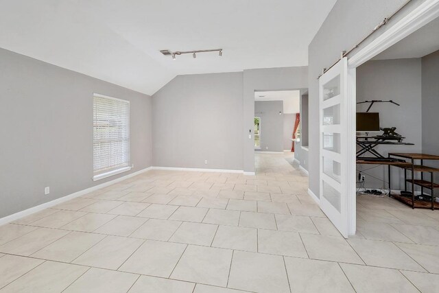 2616 Glenwood Trl, Cedar Park, TX 78613 - spare room with track lighting, lofted ceiling, light tile patterned floors, baseboards, and an office area
