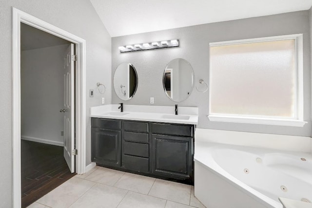 2616 Glenwood Trl, Cedar Park, TX 78613 - full bathroom with double vanity, vaulted ceiling, a tub with jets, and tile patterned flooring