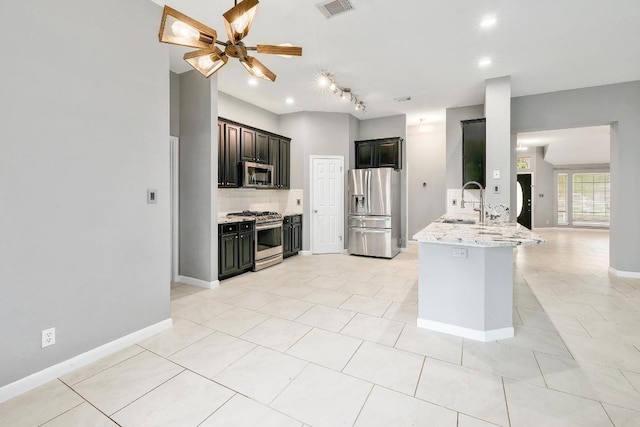 2616 Glenwood Trl, Cedar Park, TX 78613 - kitchen with stainless steel appliances, decorative backsplash, a peninsula, track lighting, and ceiling fan