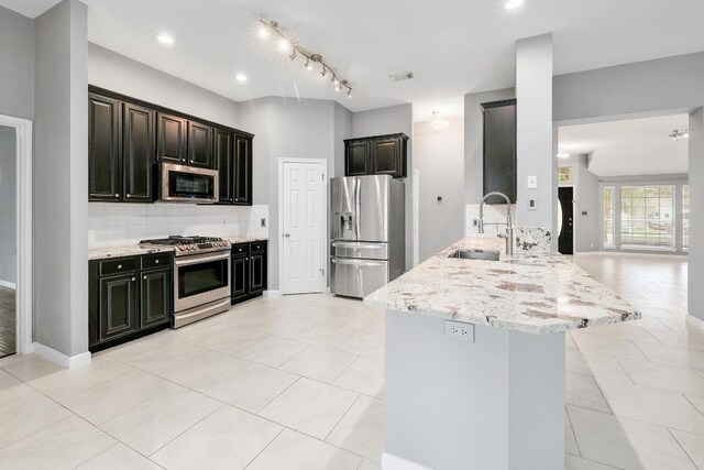 2616 Glenwood Trl, Cedar Park, TX 78613 - kitchen featuring stainless steel appliances, a sink, a peninsula, decorative backsplash, and light stone counters