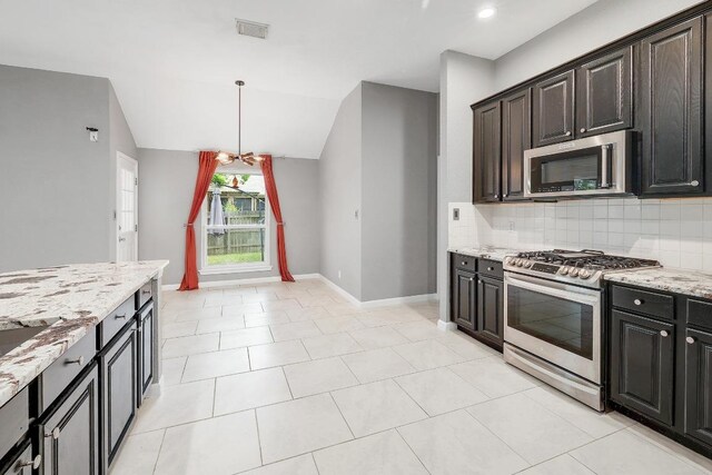 2616 Glenwood Trl, Cedar Park, TX 78613 - kitchen featuring appliances with stainless steel finishes, backsplash, light stone countertops, baseboards, and hanging light fixtures