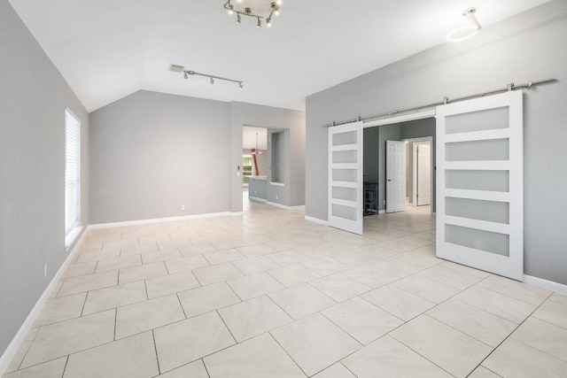 2616 Glenwood Trl, Cedar Park, TX 78613 - unfurnished living room with a barn door, rail lighting, lofted ceiling, baseboards, and light tile patterned floors