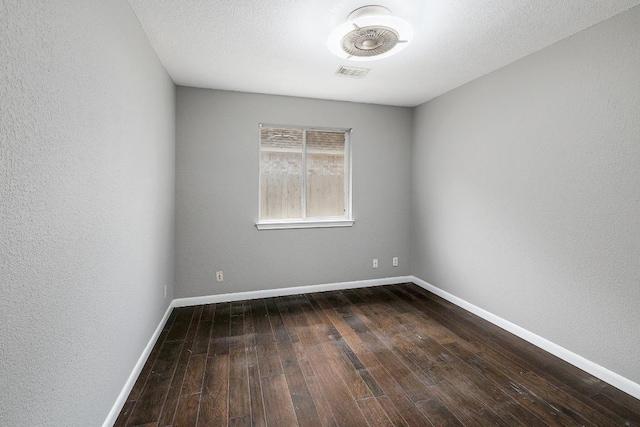 2616 Glenwood Trl, Cedar Park, TX 78613 - spare room featuring dark wood-style flooring, baseboards, and a textured wall