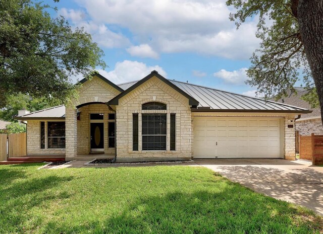 2616 Glenwood Trl, Cedar Park, TX 78613 - view of front of home with driveway, a garage, stone siding, a standing seam roof, and metal roof