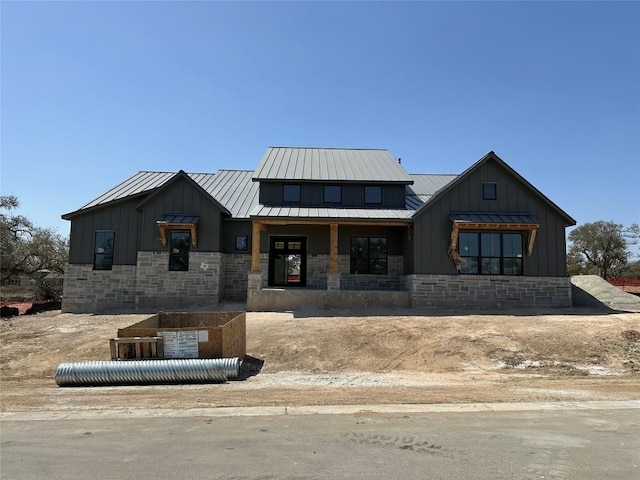 310 Crosswater Ln, Dripping Springs, TX 78620 - view of front of home with board and batten siding, stone siding, metal roof, and a standing seam roof