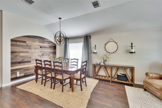 dining space with a chandelier, visible vents, dark wood-style floors, and vaulted ceiling