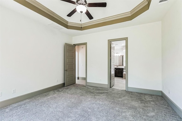 18705 Alonso Pl, Austin, TX 78738 - unfurnished bedroom featuring light carpet, a tray ceiling, ensuite bathroom, and ceiling fan