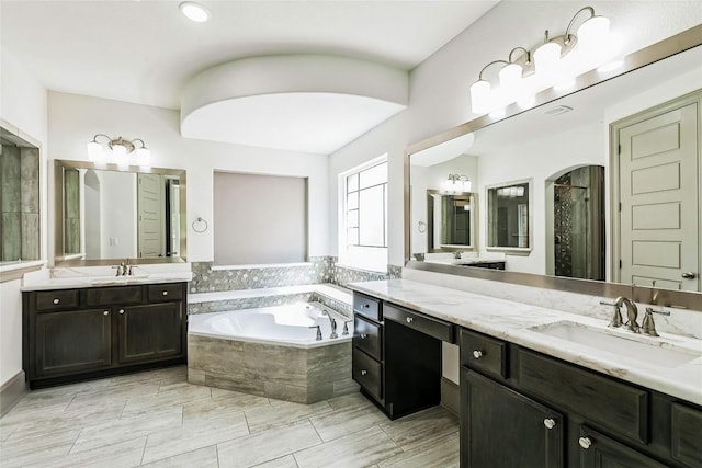 18705 Alonso Pl, Austin, TX 78738 - full bath featuring a garden tub, two vanities, and a shower stall