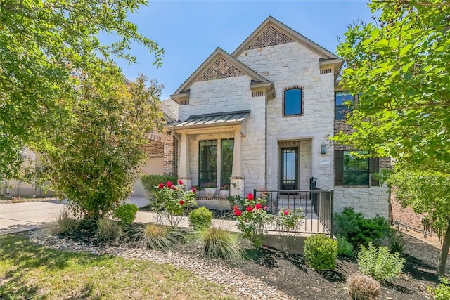 18705 Alonso Pl, Austin, TX 78738 - view of front of house with a standing seam roof, stone siding, and a metal roof