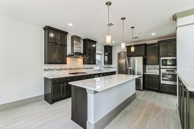 18705 Alonso Pl, Austin, TX 78738 - kitchen featuring wall chimney exhaust hood, stainless steel appliances, wood finish floors, light countertops, and recessed lighting