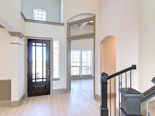 18705 Alonso Pl, Austin, TX 78738 - entryway with healthy amount of natural light, a high ceiling, stairway, and wood finished floors