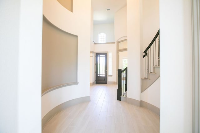 18705 Alonso Pl, Austin, TX 78738 - entryway with a towering ceiling, stairs, and light wood finished floors