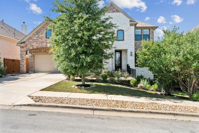 18705 Alonso Pl, Austin, TX 78738 - view of front facade with brick siding, concrete driveway, stone siding, and an attached garage