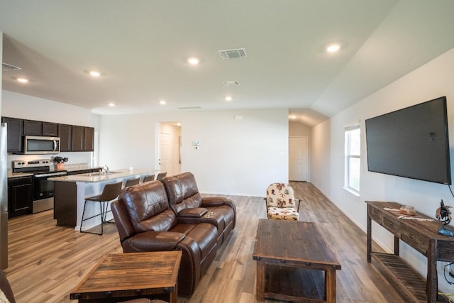 living area featuring light wood-style flooring, visible vents, and recessed lighting