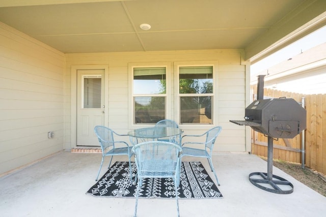 view of patio / terrace with outdoor dining space and fence