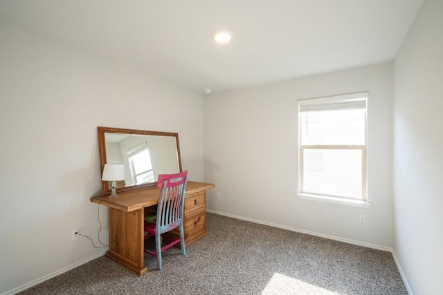 carpeted home office with baseboards