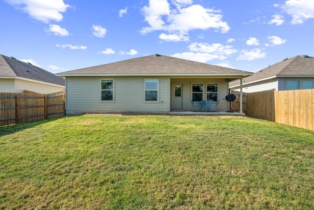 back of house with a patio area, a fenced backyard, and a lawn