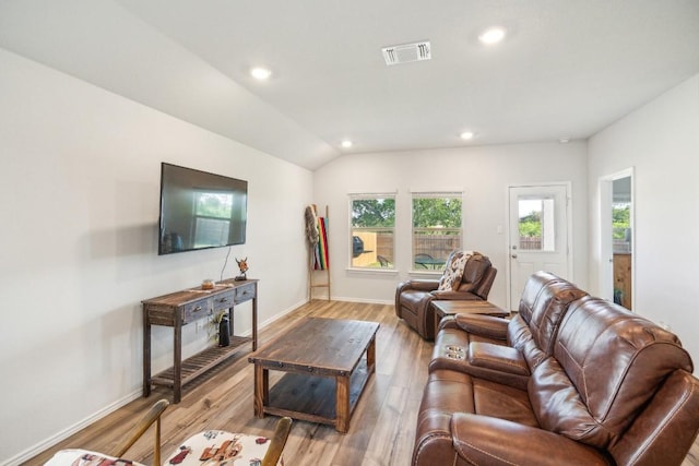 living room with recessed lighting, light wood finished floors, visible vents, and baseboards