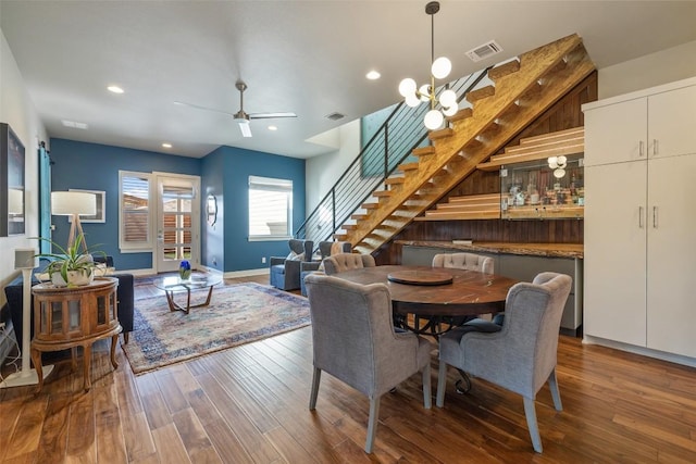 dining room with stairs, hardwood / wood-style floors, a ceiling fan, recessed lighting, and baseboards